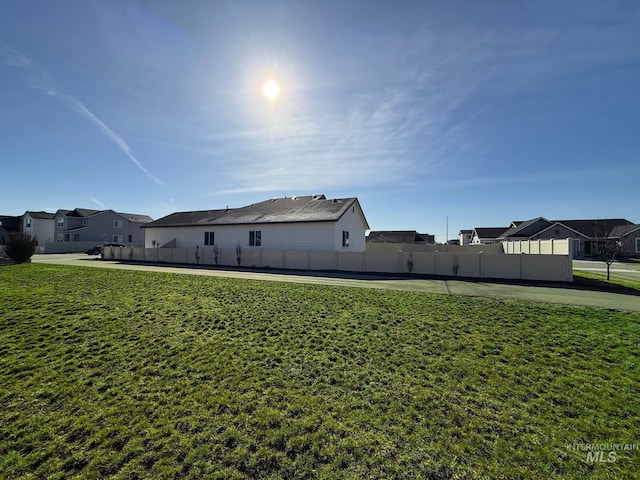 view of yard featuring a residential view and fence