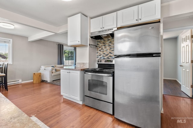 13771/2 Poplar, Clarkston, WA 99403 - kitchen featuring appliances with stainless steel finishes, under cabinet range hood, a baseboard radiator, tasteful backsplash, and white cabinets