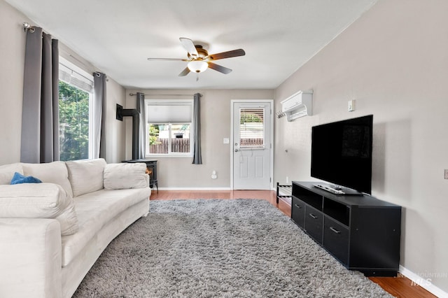 13771/2 Poplar, Clarkston, WA 99403 - living room with a wood stove, a ceiling fan, plenty of natural light, and wood finished floors