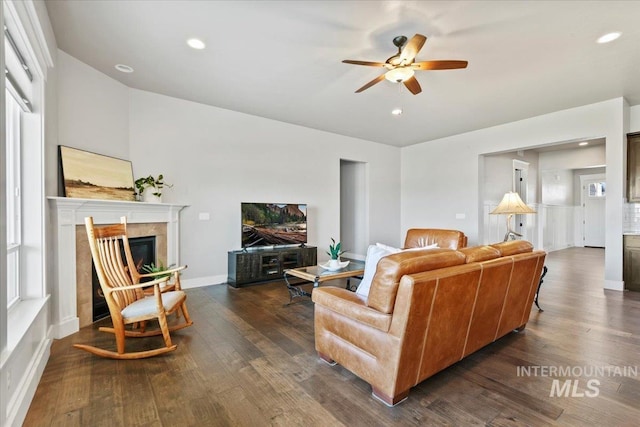 living room featuring a fireplace, dark hardwood / wood-style flooring, and ceiling fan