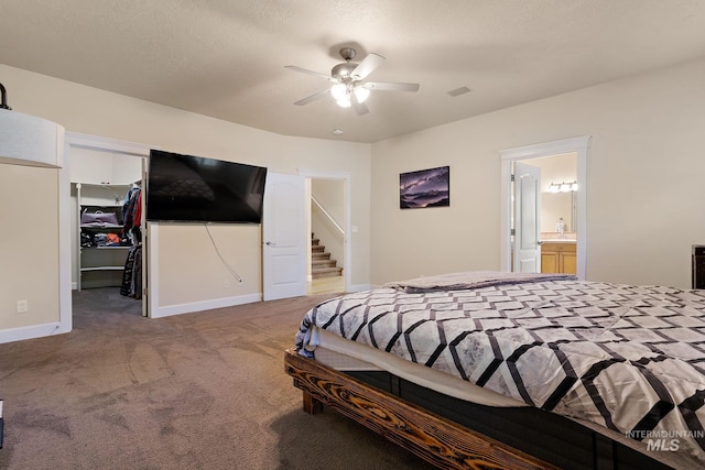 6114 N Cape Arago Pl, Boise, ID 83714 - bedroom with carpet floors, a spacious closet, connected bathroom, a closet, and baseboards