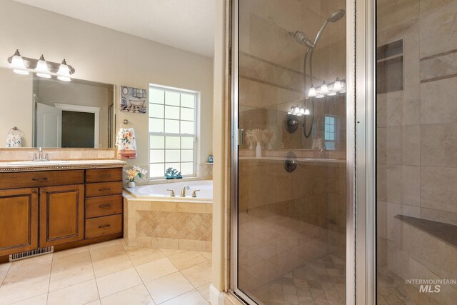 6114 N Cape Arago Pl, Boise, ID 83714 - bathroom with a bath, a shower stall, tile patterned floors, and vanity