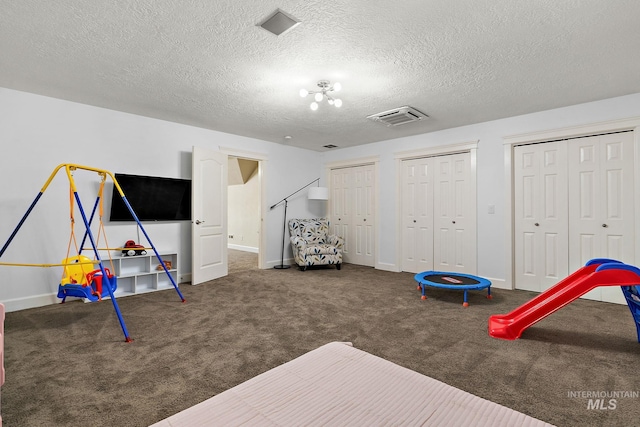 6114 N Cape Arago Pl, Boise, ID 83714 - rec room featuring a textured ceiling, baseboards, and carpet flooring
