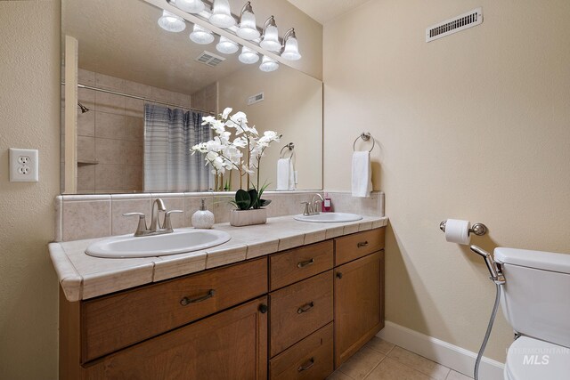 6114 N Cape Arago Pl, Boise, ID 83714 - full bathroom with toilet, tile patterned flooring, double vanity, and curtained shower