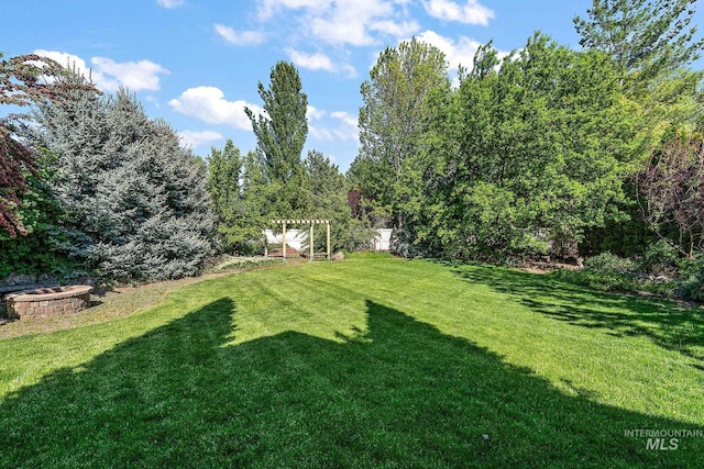 6114 N Cape Arago Pl, Boise, ID 83714 - view of green lawn with an outdoor fire pit