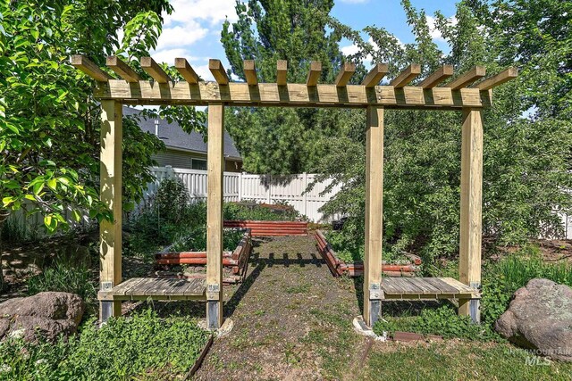 6114 N Cape Arago Pl, Boise, ID 83714 - view of yard featuring fence, a vegetable garden, and a pergola