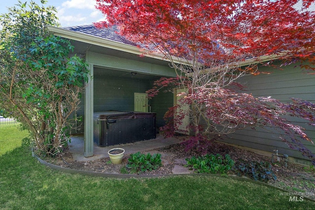 6114 N Cape Arago Pl, Boise, ID 83714 - view of side of property with a hot tub, a lawn, and a patio