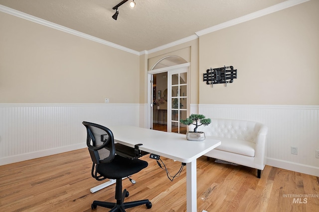 6114 N Cape Arago Pl, Boise, ID 83714 - office with wainscoting, wood finished floors, ornamental molding, a textured ceiling, and track lighting