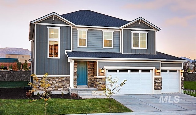 craftsman house featuring a yard and a garage