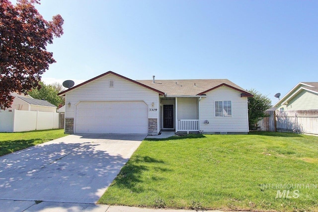 ranch-style home with fence, an attached garage, driveway, and a front lawn