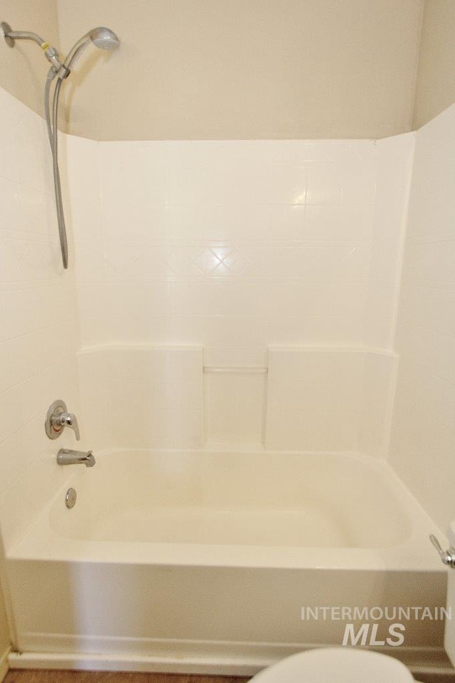 full bath featuring  shower combination and toilet