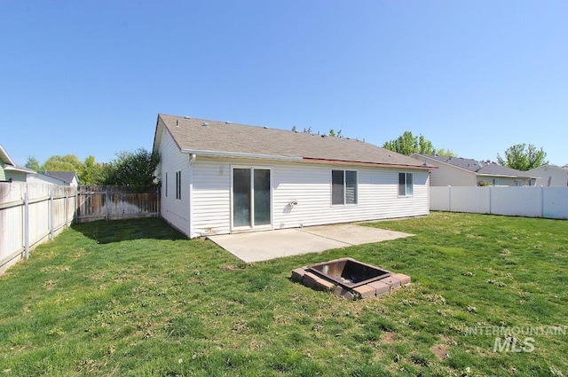 back of property with a fenced backyard, a patio, and a lawn