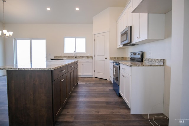 kitchen featuring dark hardwood / wood-style floors, a chandelier, stainless steel appliances, decorative light fixtures, and dark brown cabinetry