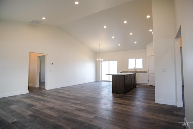 interior space with sink, high vaulted ceiling, dark hardwood / wood-style floors, and an inviting chandelier