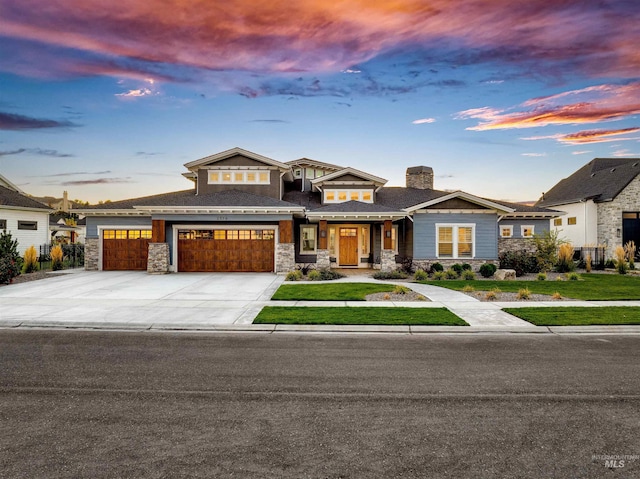 view of front of house with a lawn and a garage