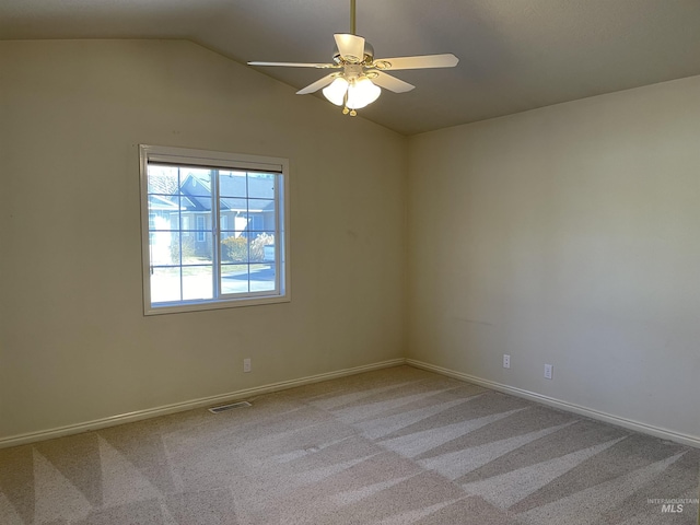 6064 N Lake Shore Ave, Garden City, ID 83714 - spare room with light carpet, visible vents, baseboards, ceiling fan, and vaulted ceiling