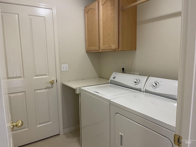 6064 N Lake Shore Ave, Garden City, ID 83714 - washroom with baseboards, cabinet space, and washing machine and clothes dryer