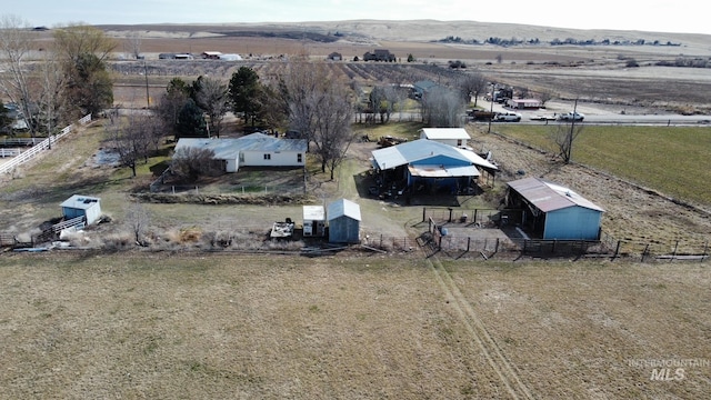 birds eye view of property with a rural view