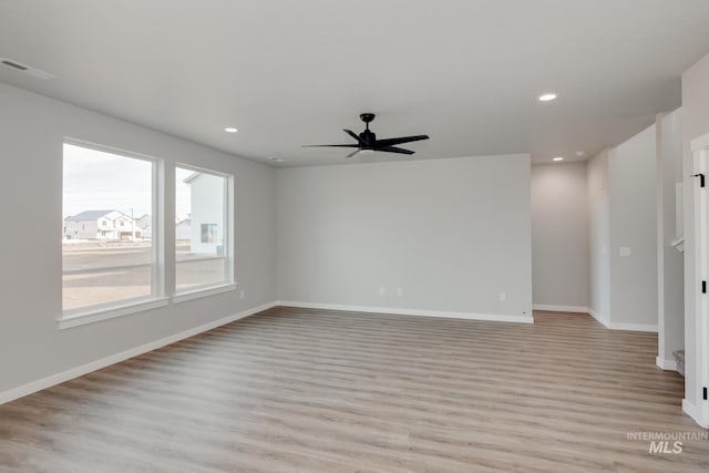 spare room featuring ceiling fan and light hardwood / wood-style floors