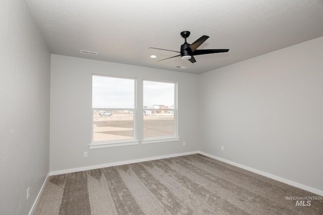 unfurnished room with carpet, a textured ceiling, and ceiling fan