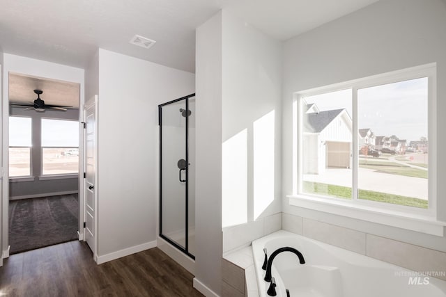 bathroom with ceiling fan, independent shower and bath, and hardwood / wood-style flooring