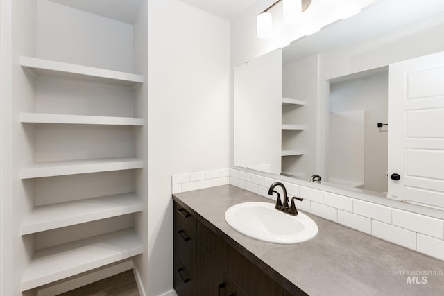 bathroom featuring vanity and decorative backsplash