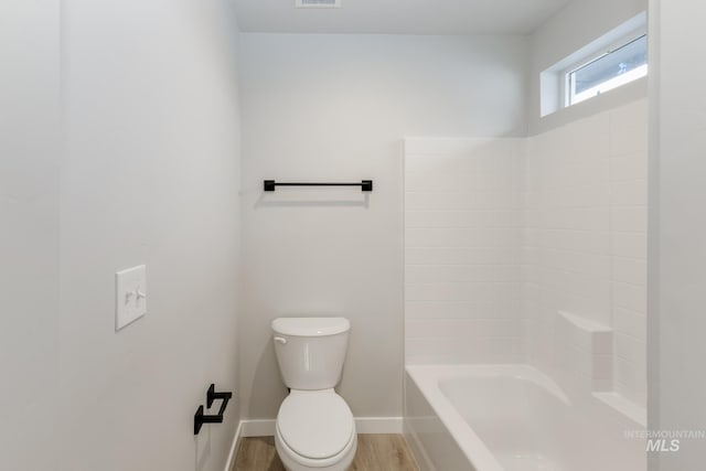 bathroom with hardwood / wood-style floors and toilet