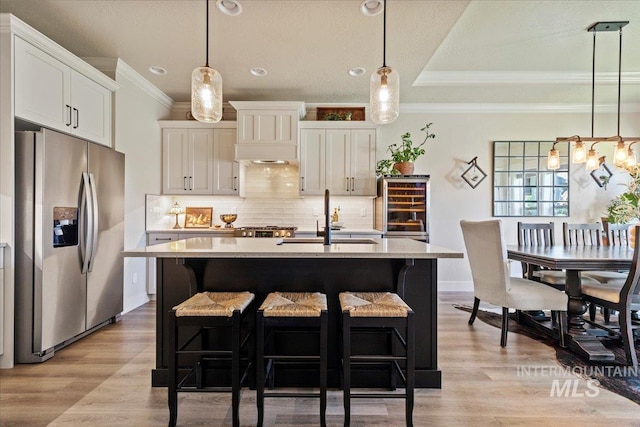 2033 E Whitetail St, Kuna, ID 83634 - kitchen with stainless steel fridge with ice dispenser, a sink, ornamental molding, decorative backsplash, and light countertops