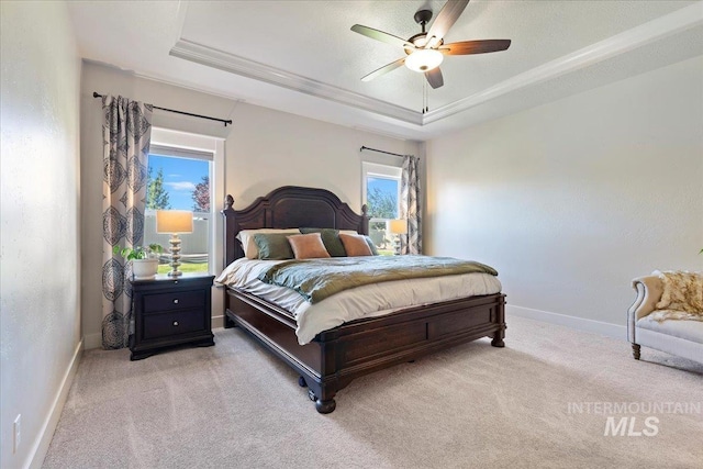 2033 E Whitetail St, Kuna, ID 83634 - bedroom featuring a raised ceiling, light carpet, baseboards, ceiling fan, and ornamental molding