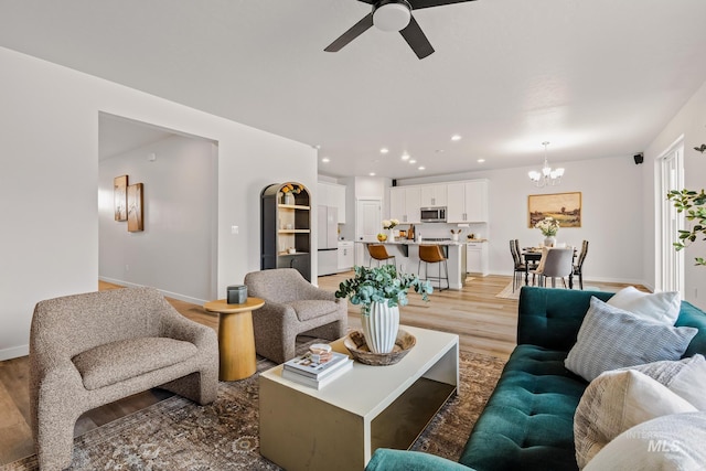 18293 N Begonia Way, Nampa, ID 83687 - living area featuring a chandelier, a ceiling fan, baseboards, light wood-style flooring, and recessed lighting