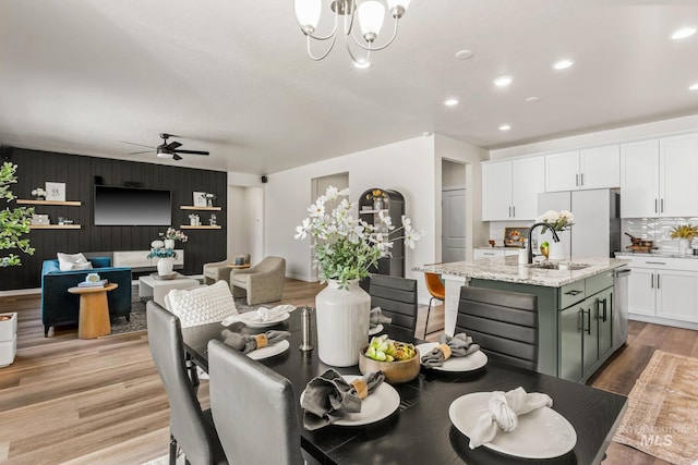 18293 N Begonia Way, Nampa, ID 83687 - dining area with a ceiling fan, recessed lighting, a chandelier, light wood finished floors, and an accent wall