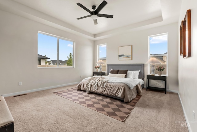 18293 N Begonia Way, Nampa, ID 83687 - bedroom featuring carpet floors, a raised ceiling, baseboards, and ceiling fan
