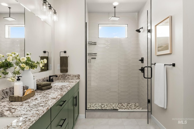 18293 N Begonia Way, Nampa, ID 83687 - full bath with double vanity, a stall shower, baseboards, and tile patterned floors