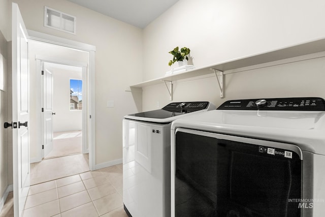 18293 N Begonia Way, Nampa, ID 83687 - washroom featuring washer and clothes dryer, baseboards, and light tile patterned floors