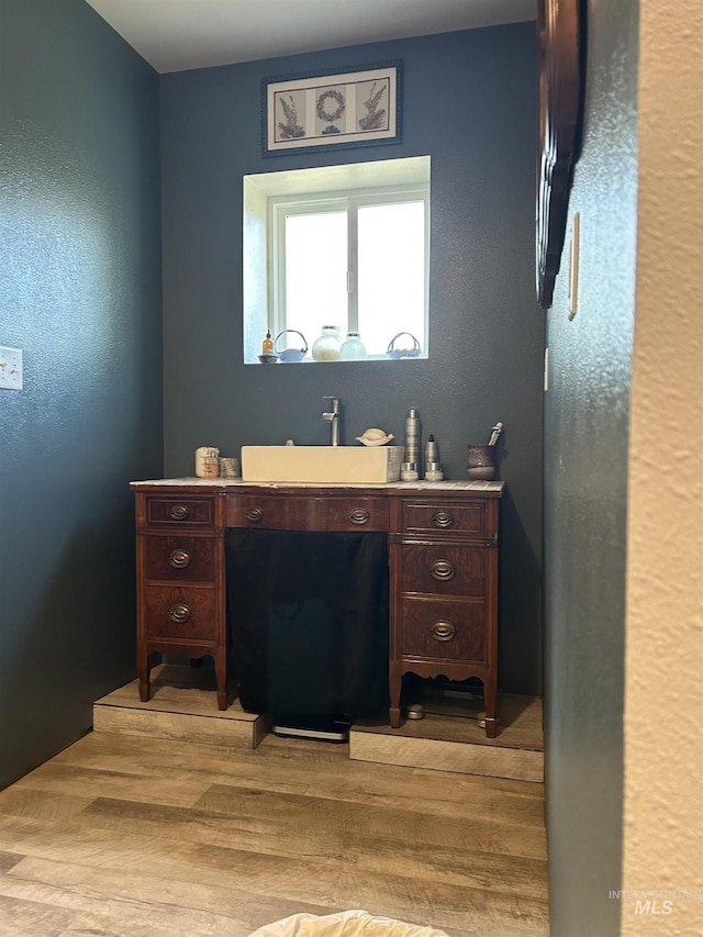 bathroom with vanity and hardwood / wood-style floors