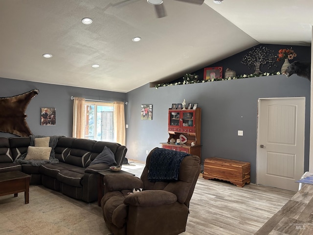 living room with vaulted ceiling, ceiling fan, and light hardwood / wood-style flooring