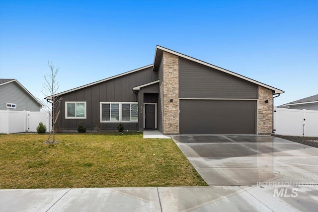 view of front facade with board and batten siding, driveway, a garage, fence, and a front lawn