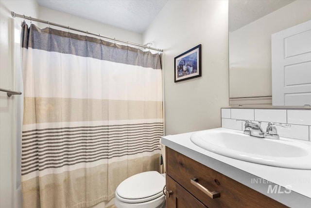 full bath featuring vanity, toilet, a textured ceiling, and shower / bath combination with curtain
