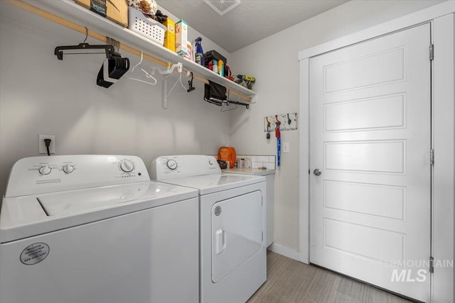 laundry area featuring laundry area, washer and clothes dryer, baseboards, and visible vents