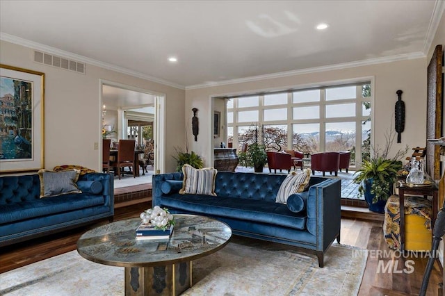 living room with visible vents, recessed lighting, wood finished floors, and ornamental molding