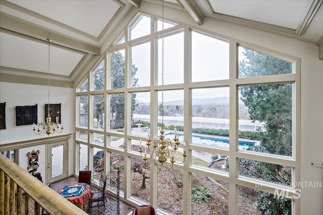 sunroom with french doors, an inviting chandelier, vaulted ceiling with beams, and a healthy amount of sunlight