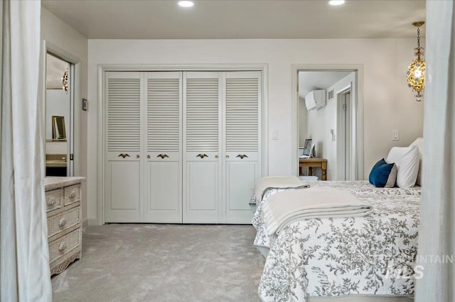 bedroom with carpet flooring, recessed lighting, a closet, and a wall mounted AC