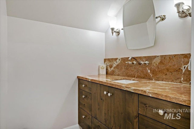 bathroom with decorative backsplash and vanity