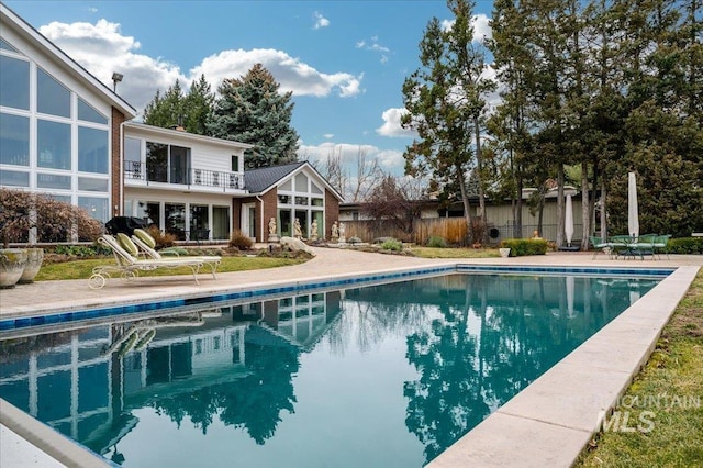 view of pool with a fenced in pool, a patio area, and fence