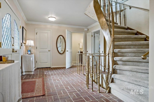 entryway featuring stairs, crown molding, baseboards, and brick floor