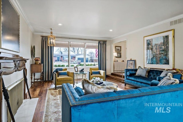 living area with recessed lighting, visible vents, wood finished floors, and ornamental molding