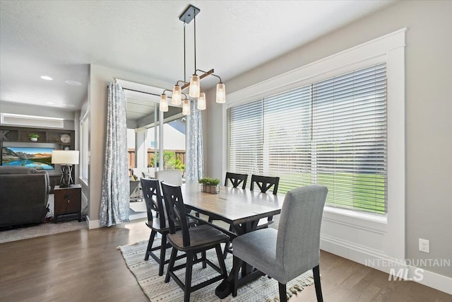 5988 N Lichfield Ave, Meridian, ID 83646 - dining area featuring baseboards, wood finished floors, and a notable chandelier