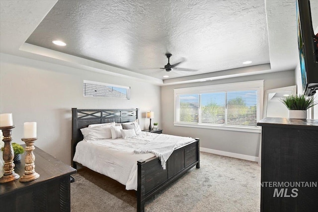 5988 N Lichfield Ave, Meridian, ID 83646 - bedroom with a textured ceiling, baseboards, light colored carpet, and a raised ceiling