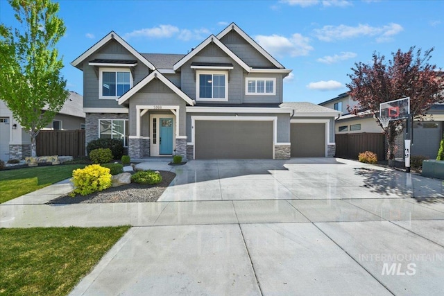 5988 N Lichfield Ave, Meridian, ID 83646 - craftsman-style home with fence, concrete driveway, a garage, and stone siding