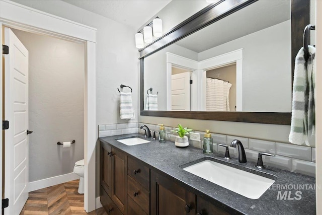 5988 N Lichfield Ave, Meridian, ID 83646 - full bathroom featuring a sink, baseboards, toilet, and double vanity